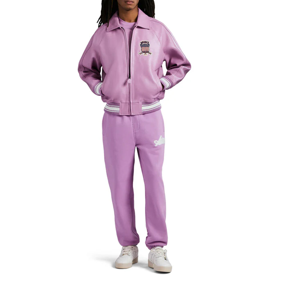 Person wearing a purple tracksuit with white accents on a white background