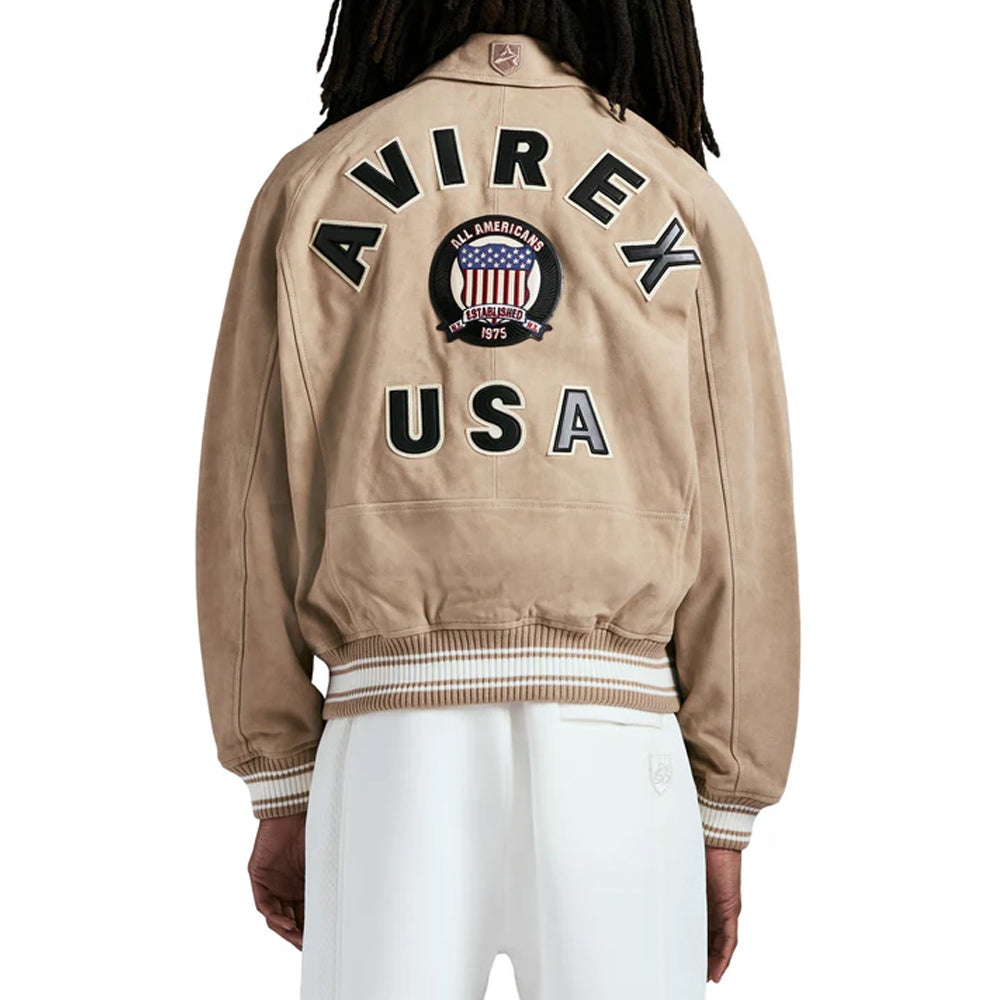 Beige Avirex jacket with 'Avirex USA' text on the back, worn by a person.