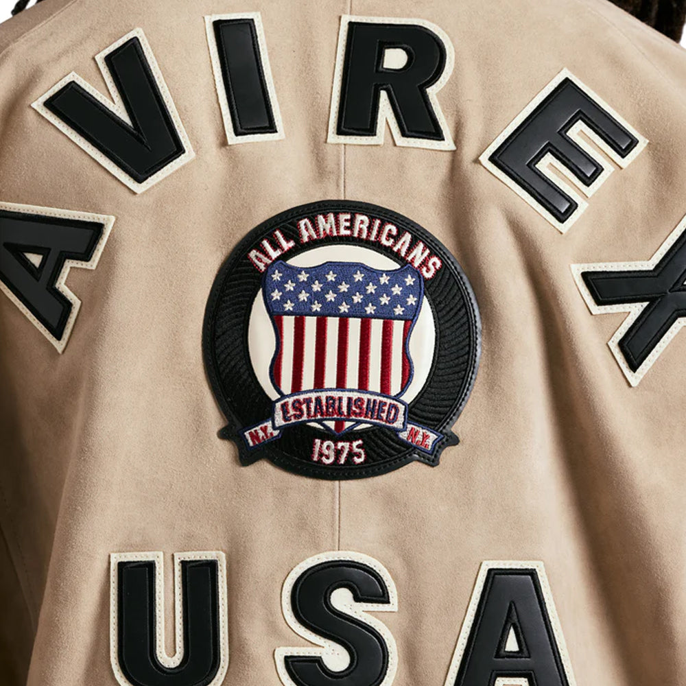 Vintage baseball jersey with 'AVIREX' branding and an American flag patch on a beige background.