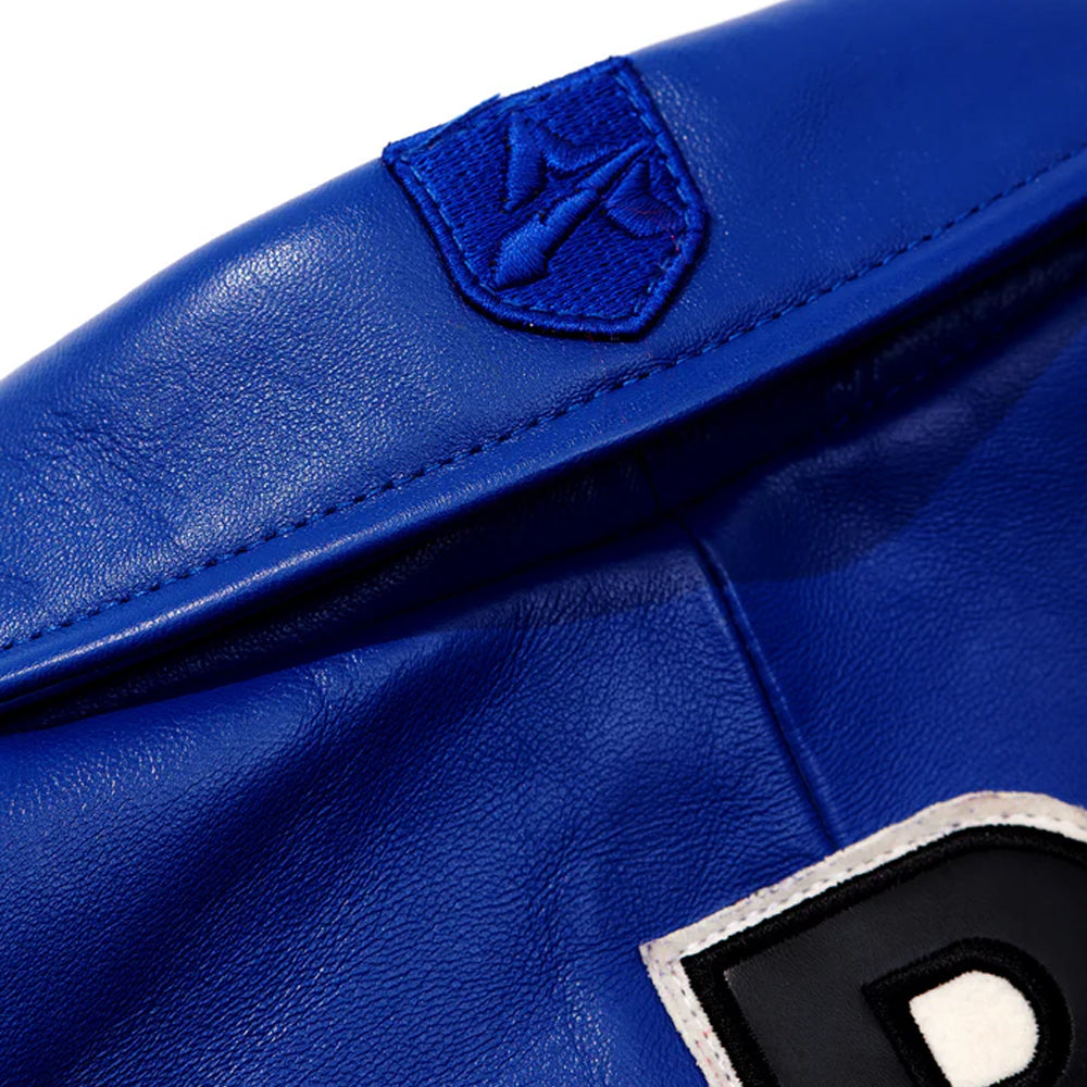 Close-up of a blue leather glove with a brand logo on a white background
