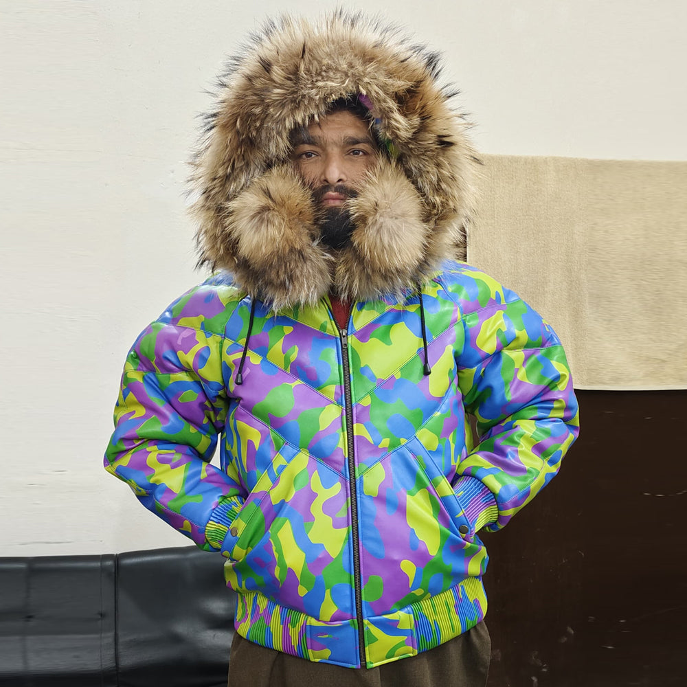 Model wearing Men's Camo Leather V-Bomber Jacket with hood up and front zip closed, showcasing a snug winter look.