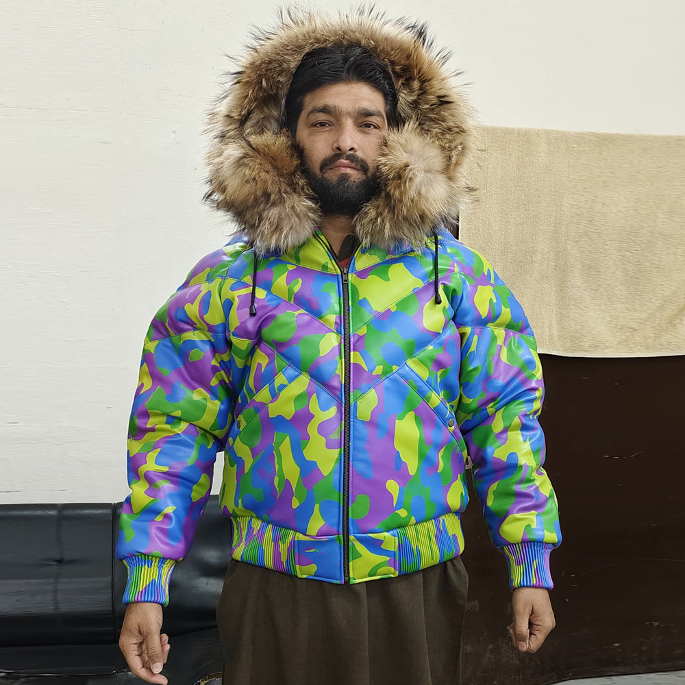 Model wearing Men's Camo Leather V-Bomber Jacket with hood up and front zip closed, showcasing a snug winter look.