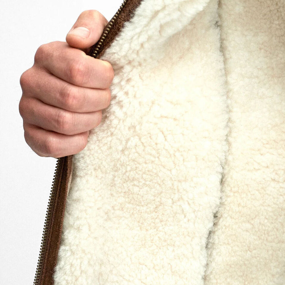 Luxurious shearling lining extending through the body, collar, and cuffs for unmatched warmth and comfort.