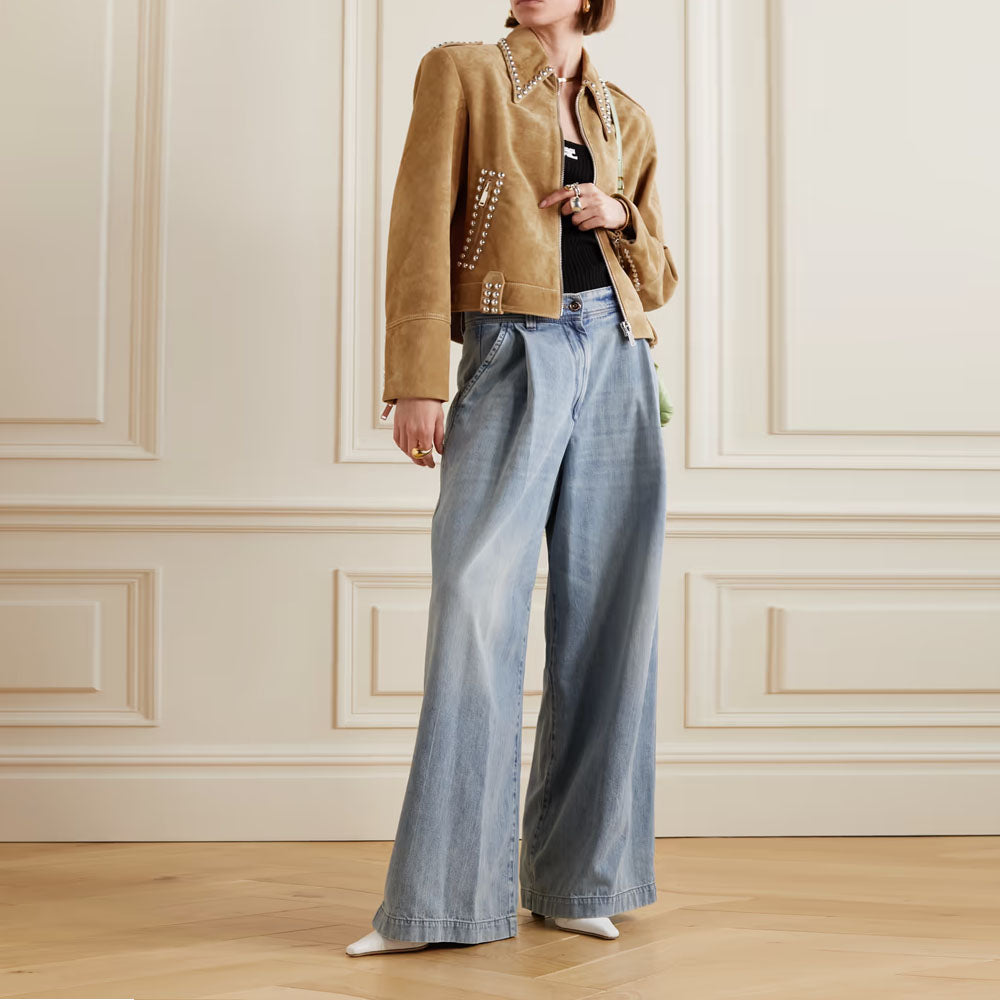 A side view of the brown suede leather jacket shows its tailored fit and precise detailing on the sleeves and waist.