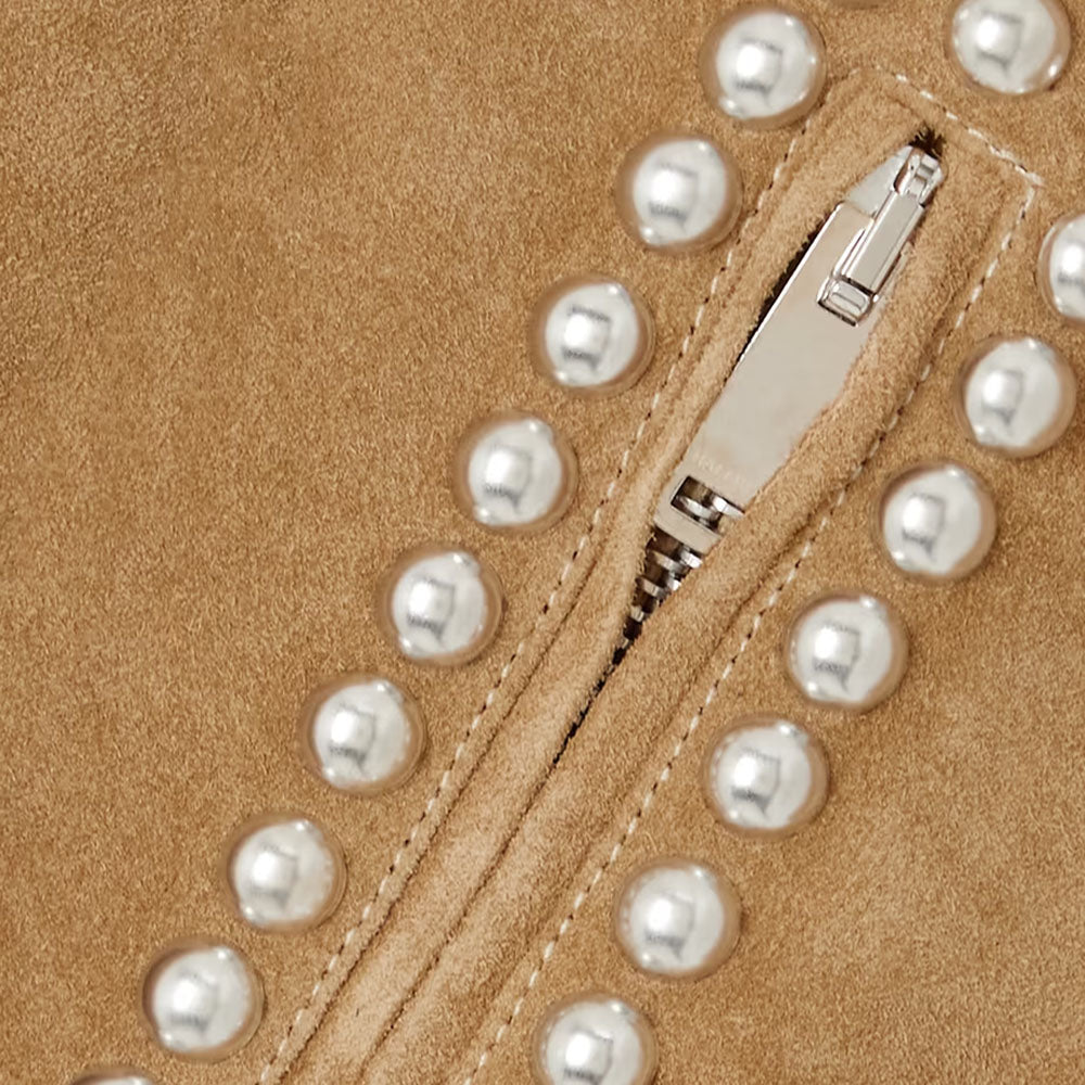 A close-up of the pearl embellishments on the brown suede leather jacket's collar highlights intricate craftsmanship.