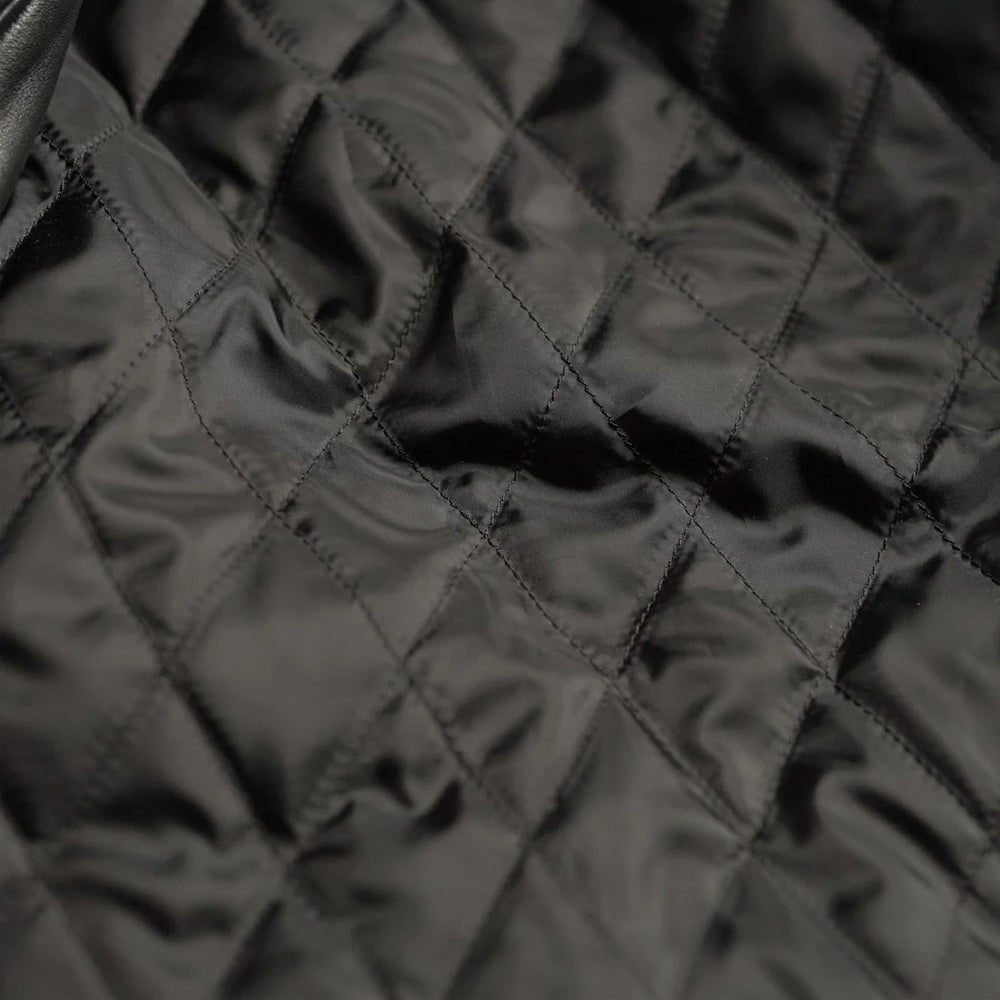 Close-up of the soft lining inside the men's leather bomber jacket.