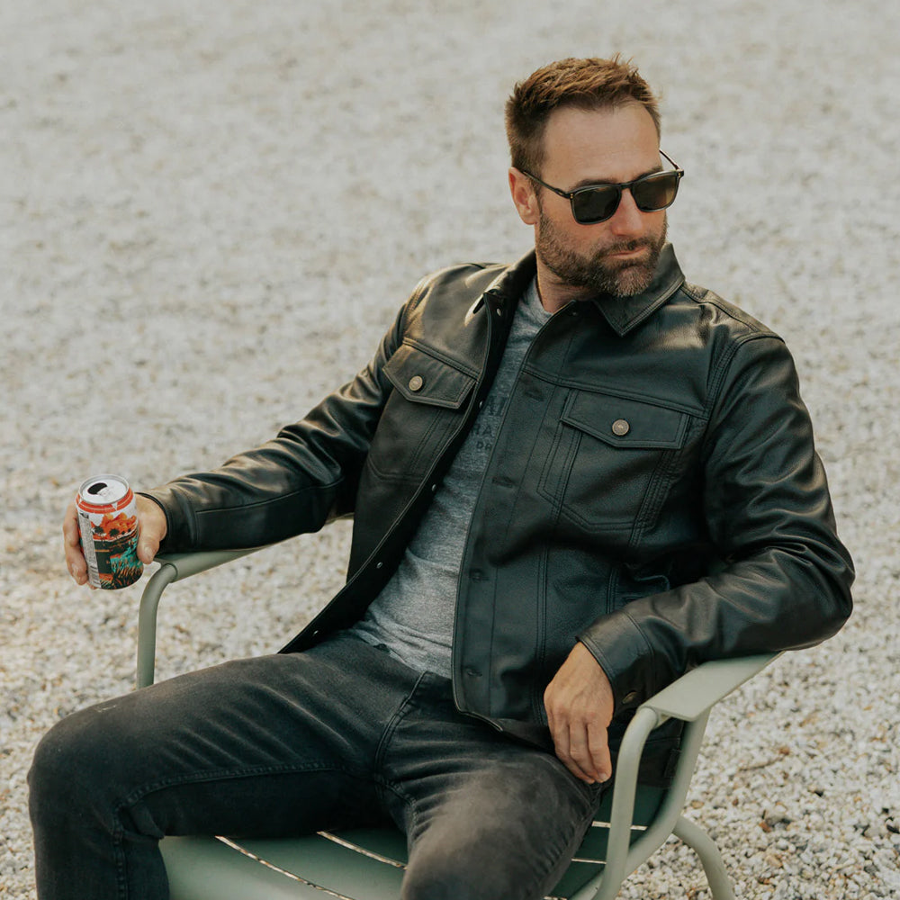 Side view of Men’s Black Lambskin Leather Trucker Jacket highlighting fit and design.