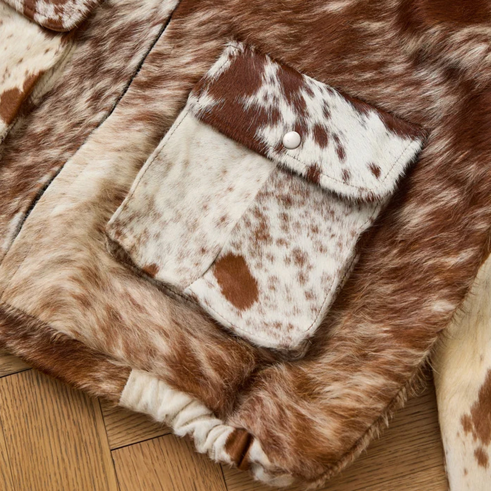 Detail of the cowhide snap flap patch pocket, reinforced topstitching and gathered elastic sleeve cuff