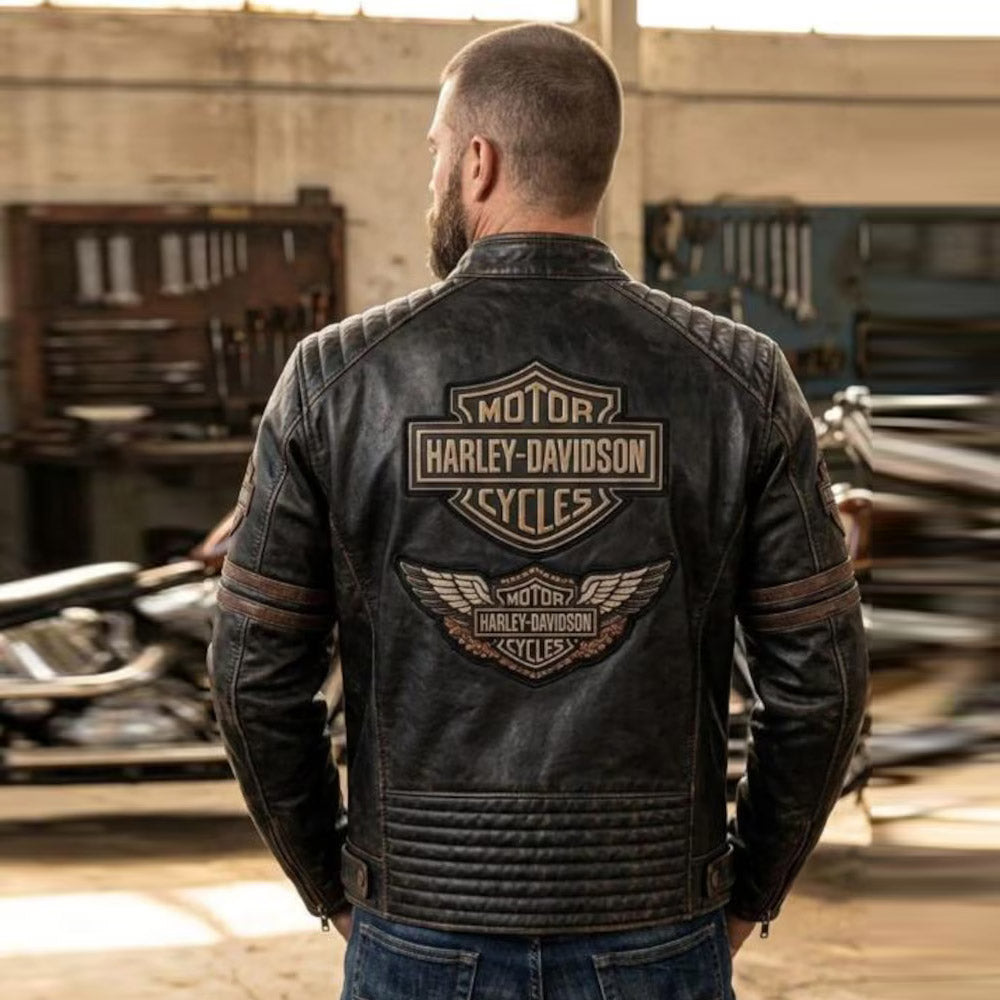 Man wearing brown Harley-Davidson leather jacket showing large back logo patch in garage