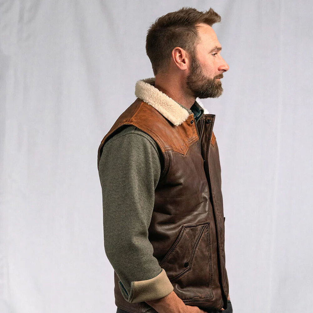 Side profile view of a man wearing the brown double-face shearling waistcoat.