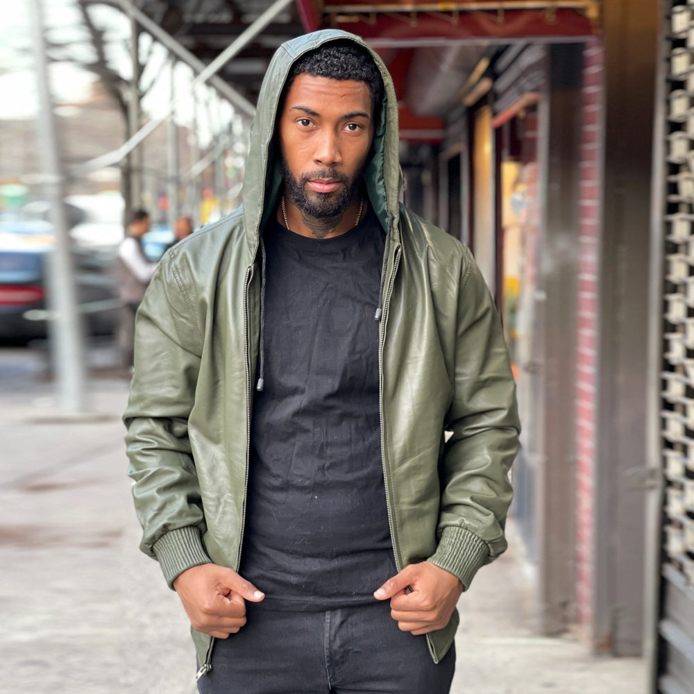 Open-front view of men’s green leather zip hoodie displaying the attached hood, smooth shell, shaped sleeves and olive rib-knit cuffs.