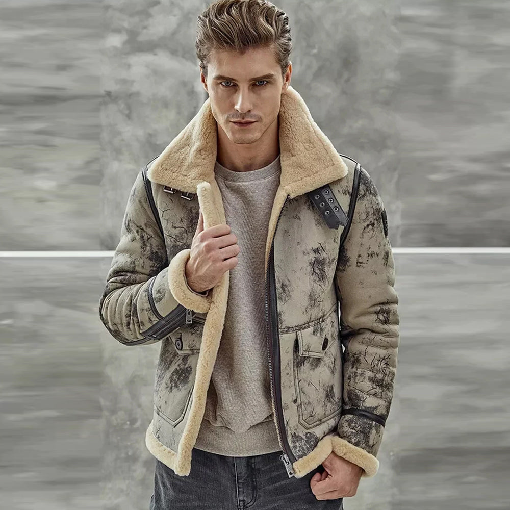 Male model standing outdoors wearing an open distressed crackle B-3 shearling jacket over a grey sweater