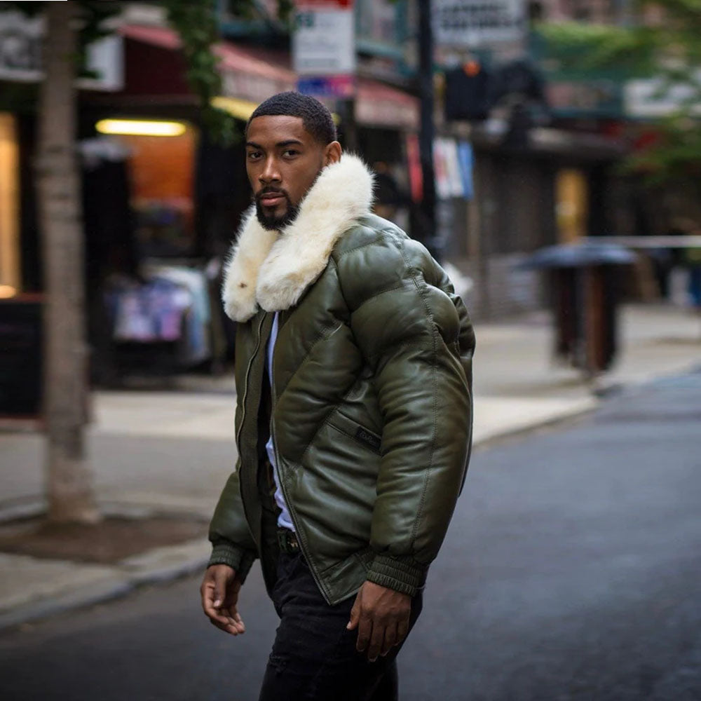 A model on the street wearing the money green sheepskin leather down puffer coat, showing the clear side profile view of the jacket.
