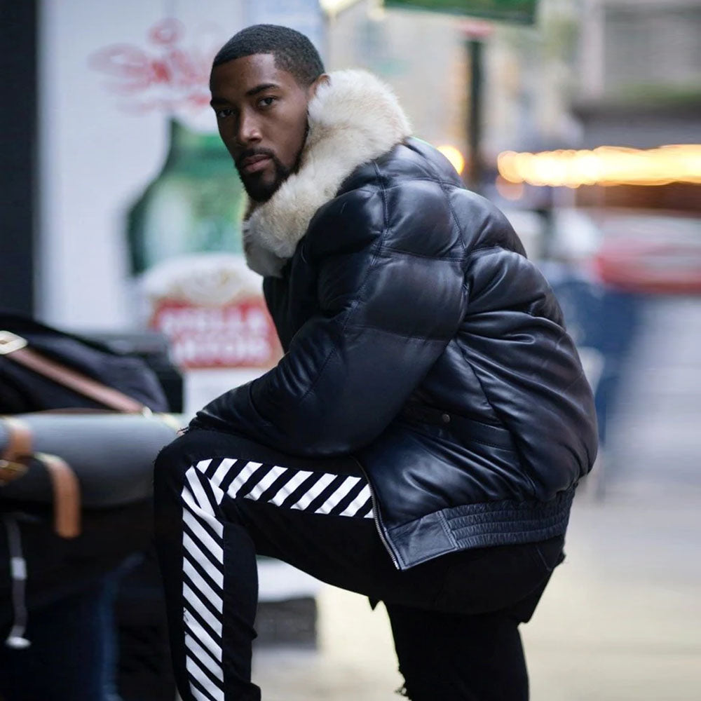 A model standing outside showing the clear side profile view of the navy blue sheepskin leather down puffer coat.