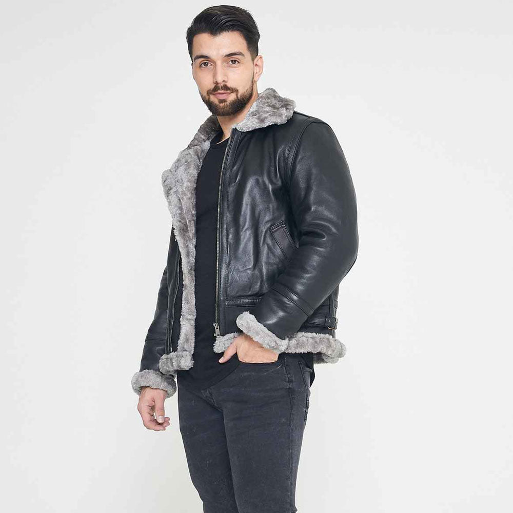 Model wearing a shearling aviator jacket paired with jeans and boots, showcasing a rugged winter outfit.