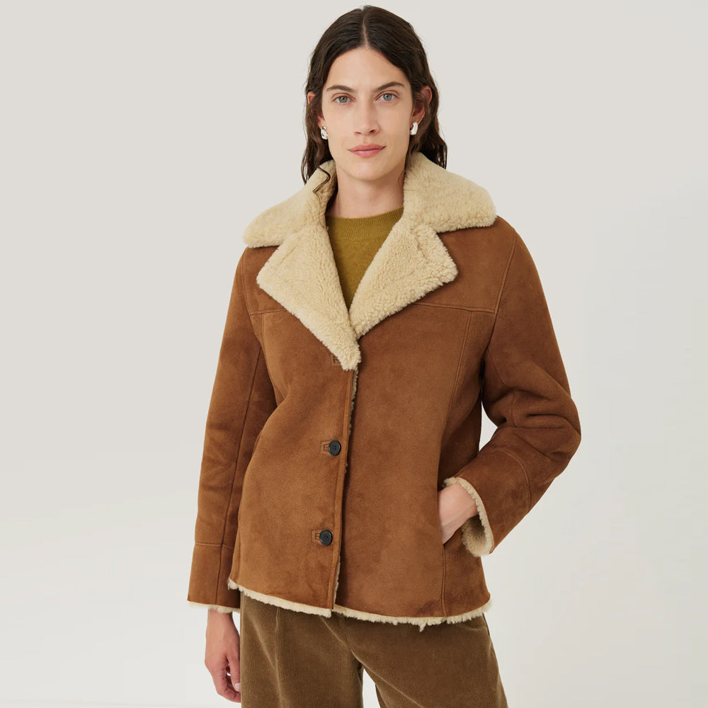 Women’s Tan Shearling Leather Sheepskin Jacket with plush fur lining, stylish design, and premium quality for warmth and comfort.