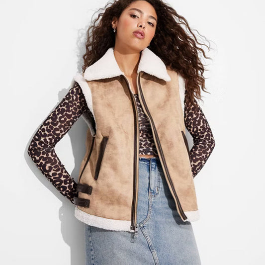 Fashionable woman wearing a stylish shearling vest, showcasing warmth and elegance, perfect for winter layering and versatile outfit styling.