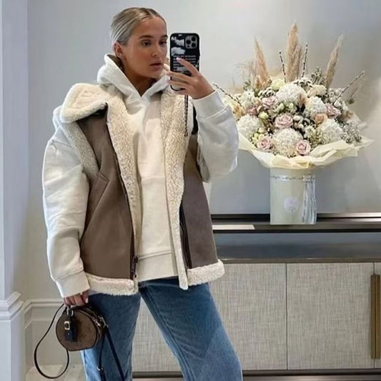 Woman wearing a shearling vest with jeans and a sweater for a casual winter look.