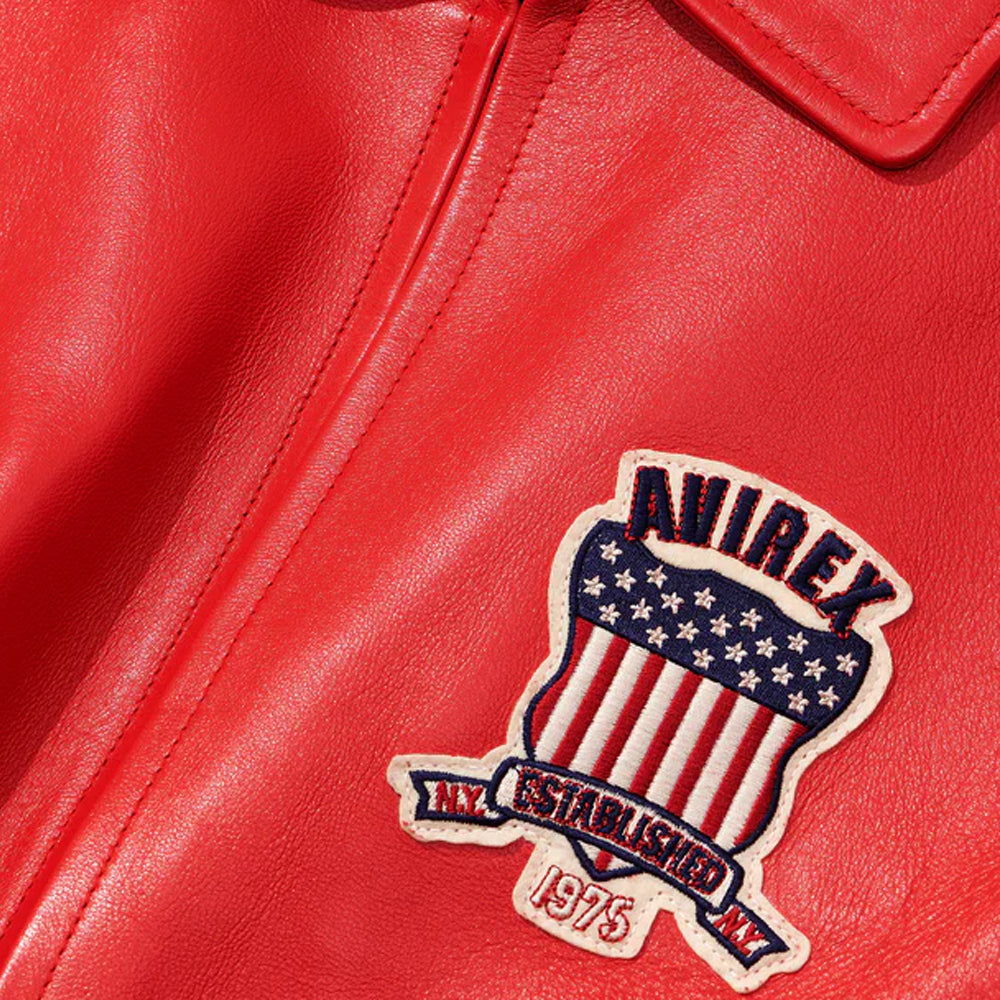 Red leather jacket with a patch featuring an American flag design and 'Dainese' branding.