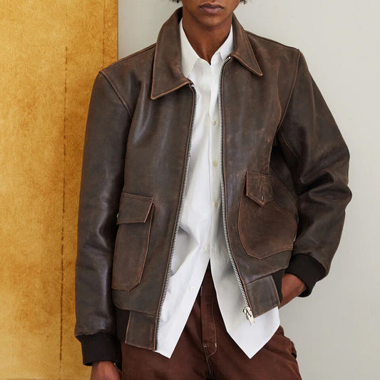 Man wearing the RAF Vintage A2 Brown Leather Bomber Jacket with the front zipper open and one hand in the jeans pocket.