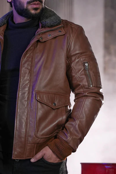 Storm placket and front zip closure of tan leather flight jacket