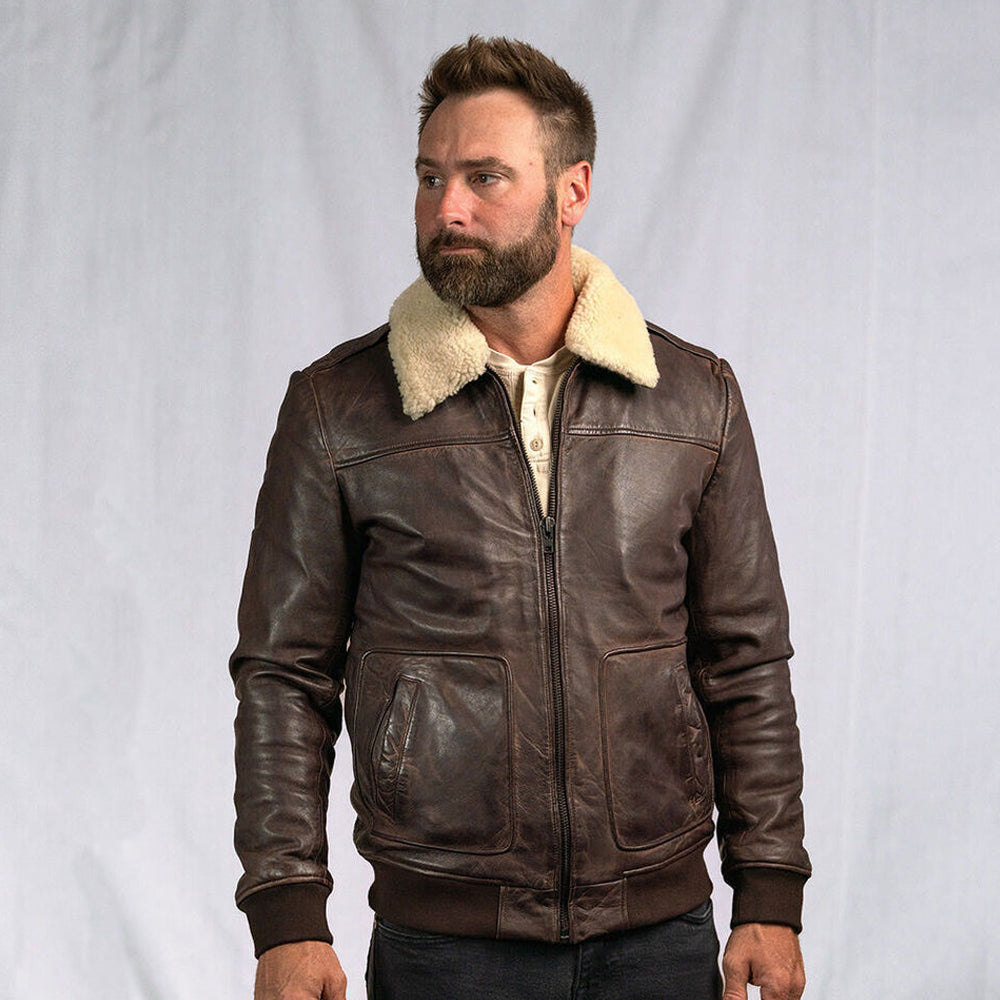 Men standing in vintage bomber jacket outdoors during fall