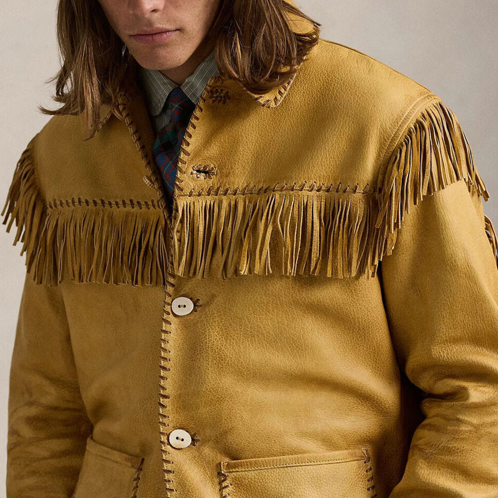 Detailed close-up of beadwork and embroidery on a Western leather jacket.