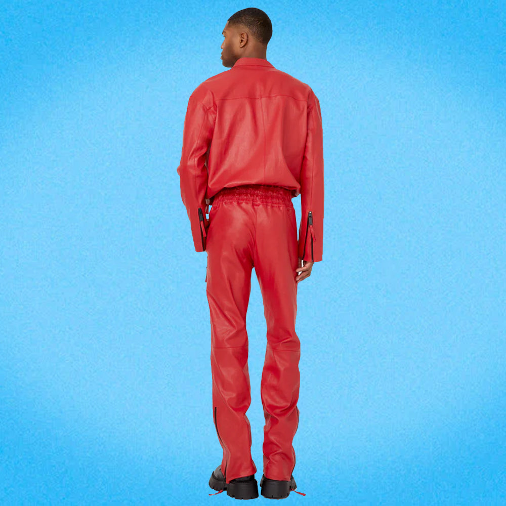 Man showcasing the back of the red leather jumpsuit, highlighting the sleek fit, elastic waistband, and smooth genuine leather finish.