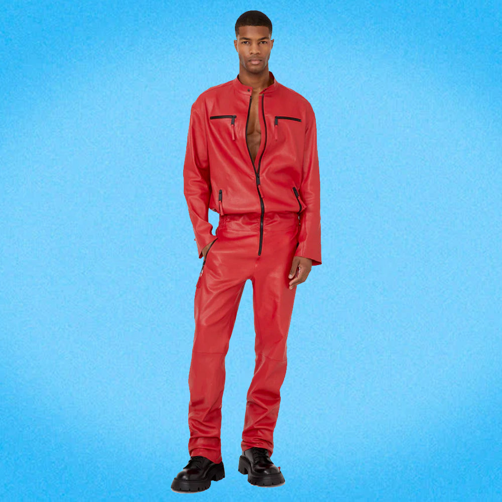 Man wearing a red leather jumpsuit with the front zipper slightly open, revealing a stylish and edgy look with contrast zipper details.