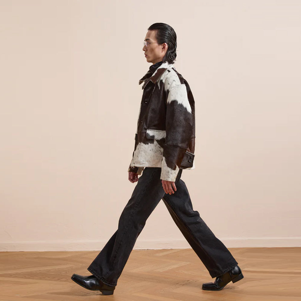 Vintage inspired cow print jacket featuring genuine leather and classic ranch style