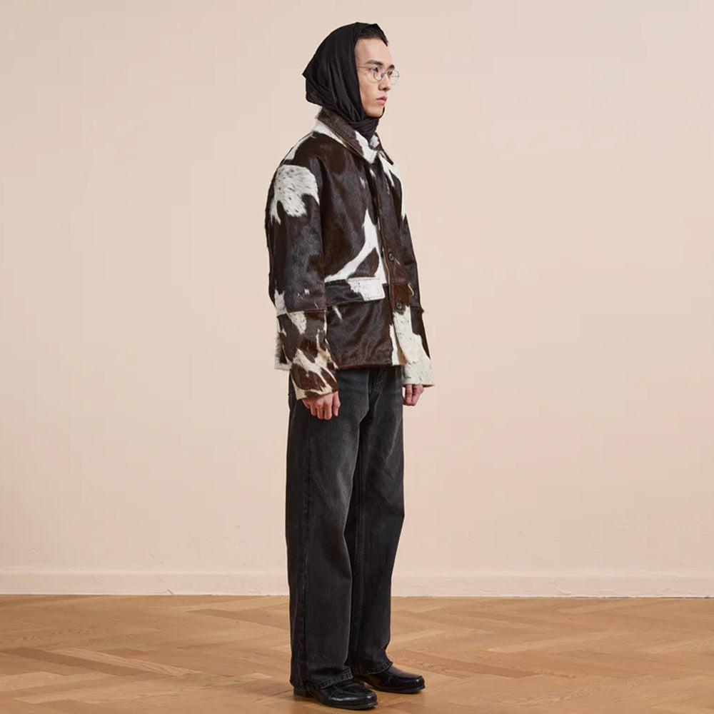 Statement cowhide print jacket featuring chocolate and ivory coloring with buttons
