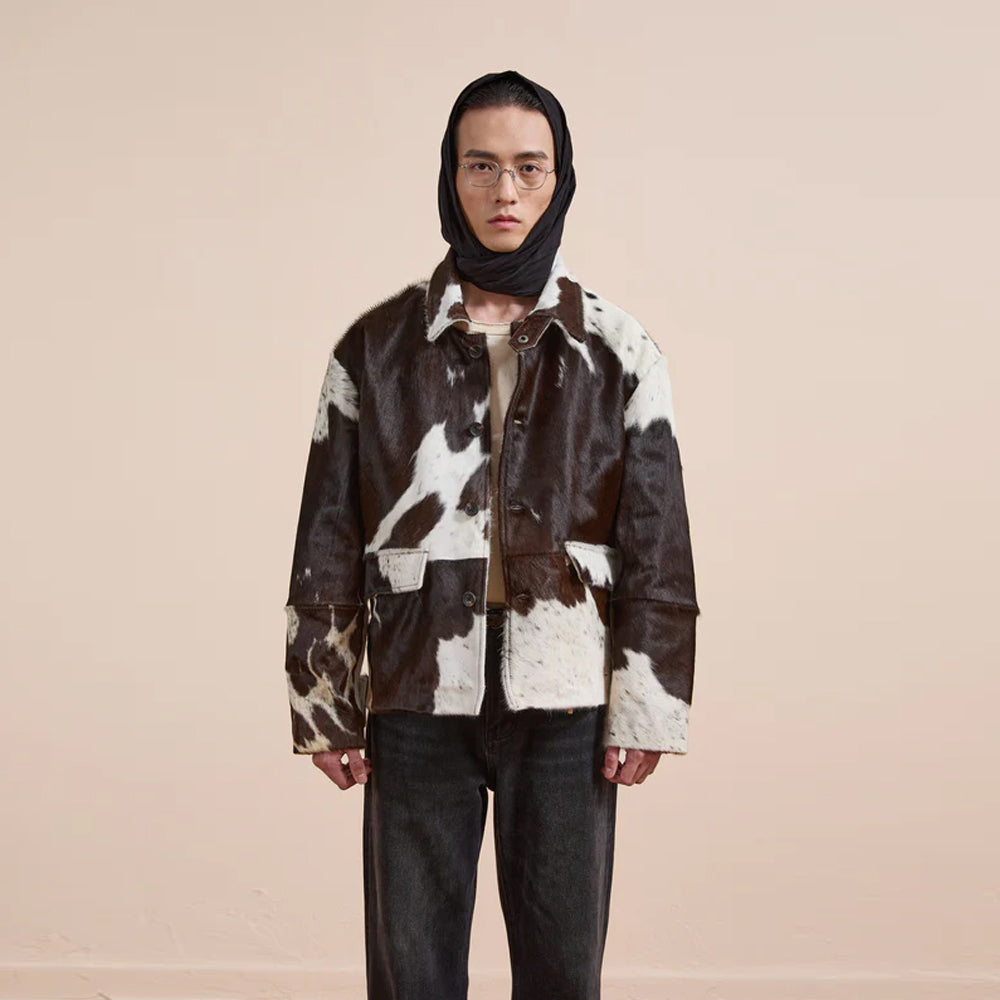 Fashion forward cowhide print jacket with rustic appeal and functional styling