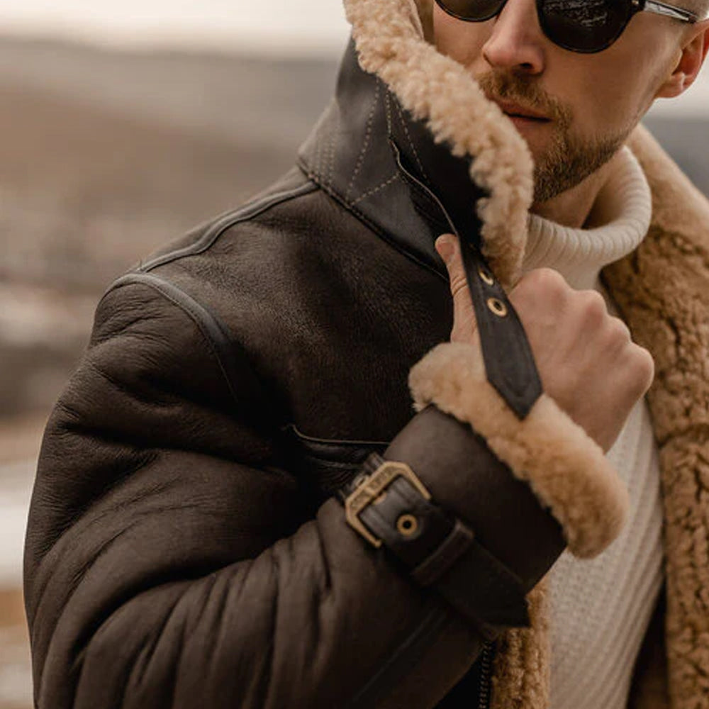 Close-up of the collar and cuffs of the B3 Sheepskin Jacket, with the man holding the collar, emphasizing the faux fur lining and craftsmanship.