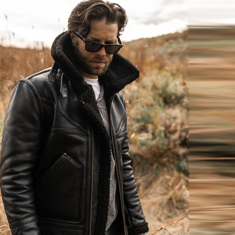 Man wearing Men's Shearling Sheepskin Jacket in a slight side pose with the collar standing up for added style.