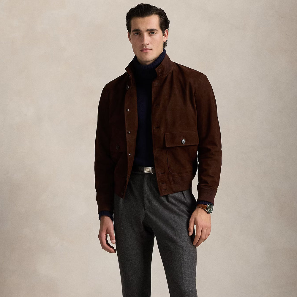 Model styling a men's brown suede leather jacket with dress pants, featuring an open front closure and modern elegance.