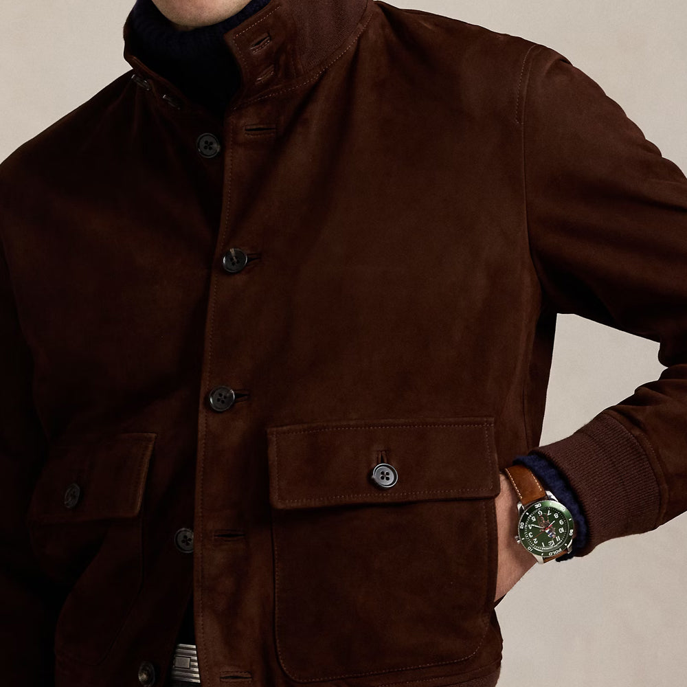 Close-up of the front pocket detail on a men's brown suede leather jacket, emphasizing craftsmanship and functionality.