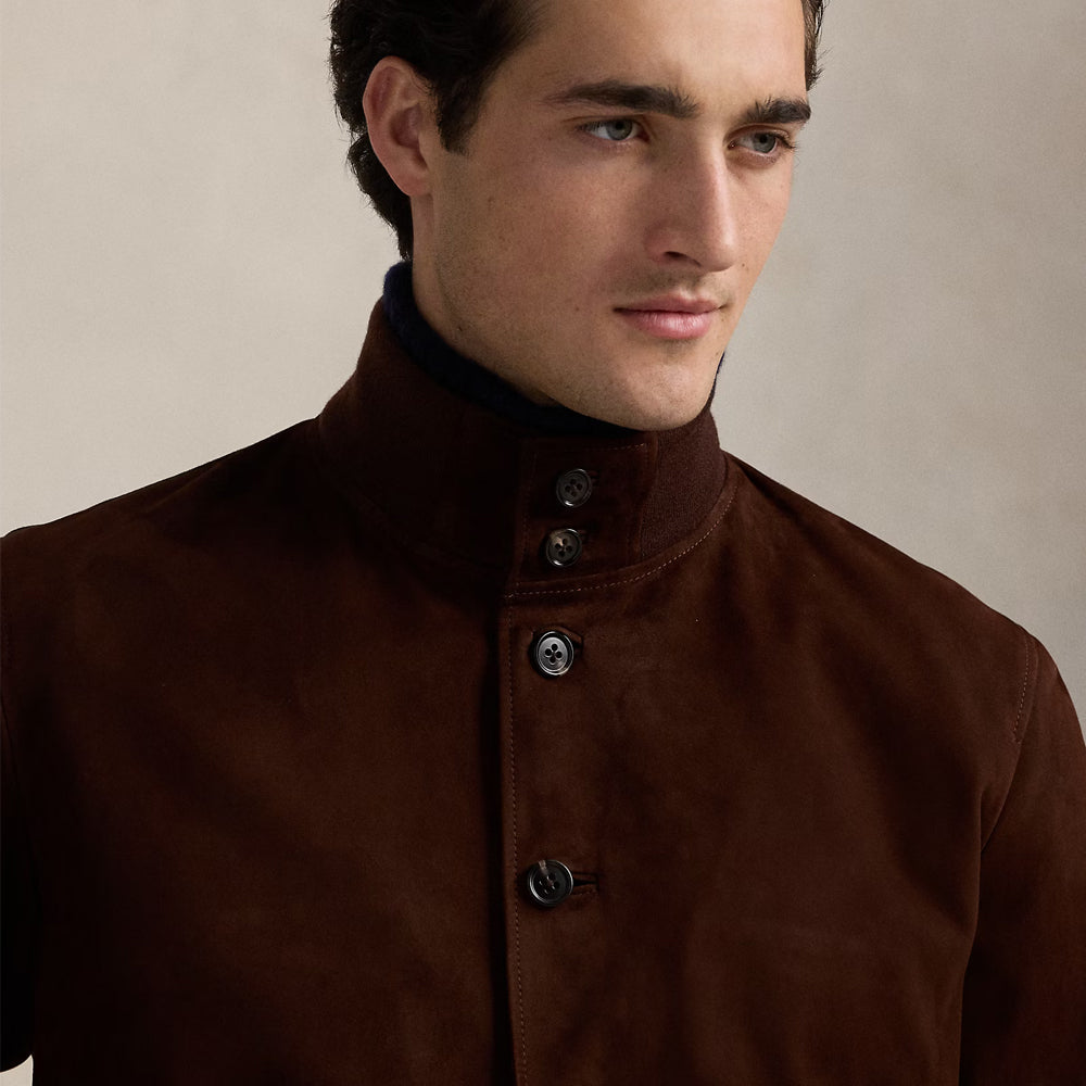 Detailed view of the stand-up collar and button closure on a men's brown suede leather jacket, highlighting premium design.