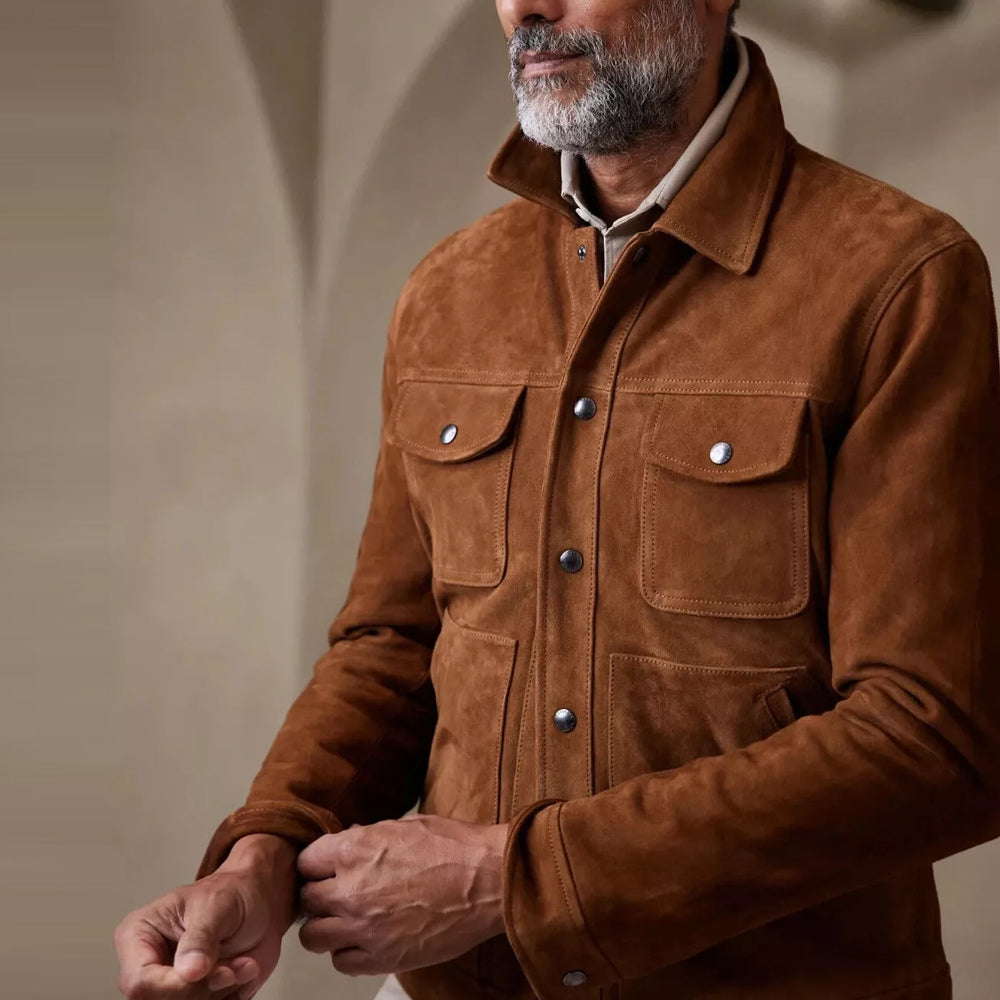 Man wearing a brown suede leather jacket, focusing on the front button closure and cuff details.