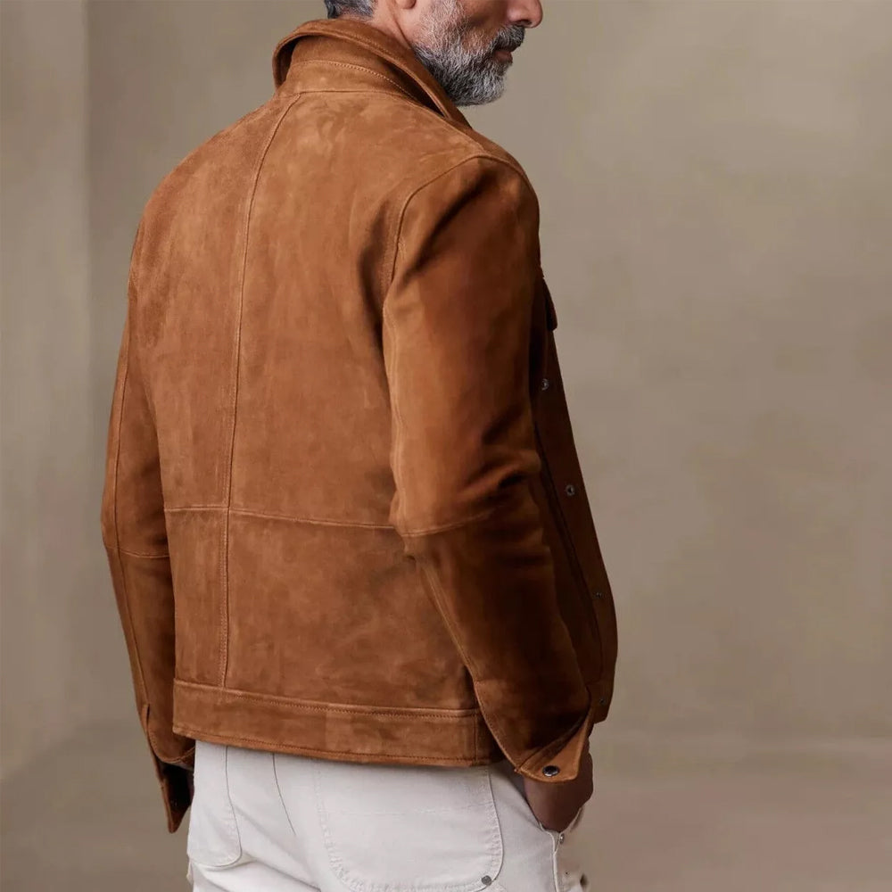 Man wearing a brown suede leather jacket, slightly turned back to highlight the jacket's structure and fit.