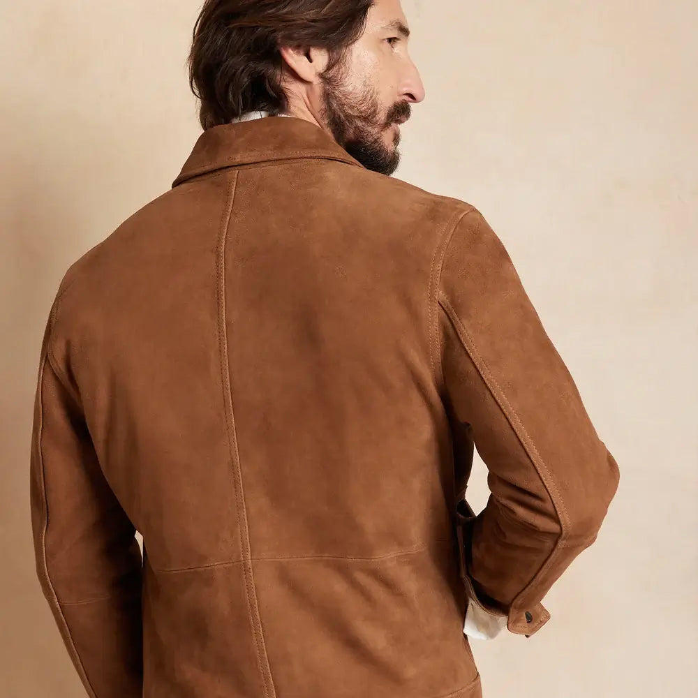 Back view of a man wearing a brown suede leather jacket, highlighting the smooth suede finish.