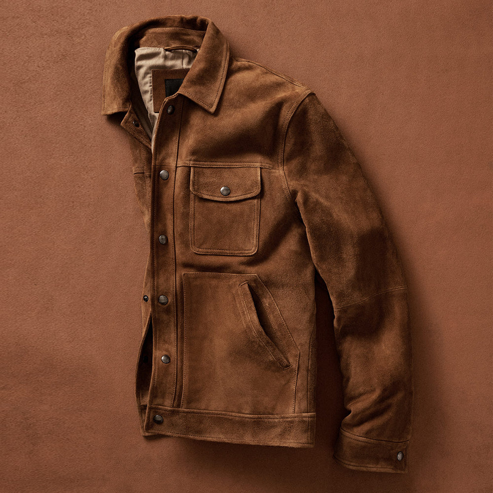 Brown suede leather jacket displayed in a front side view, with one sleeve neatly folded.