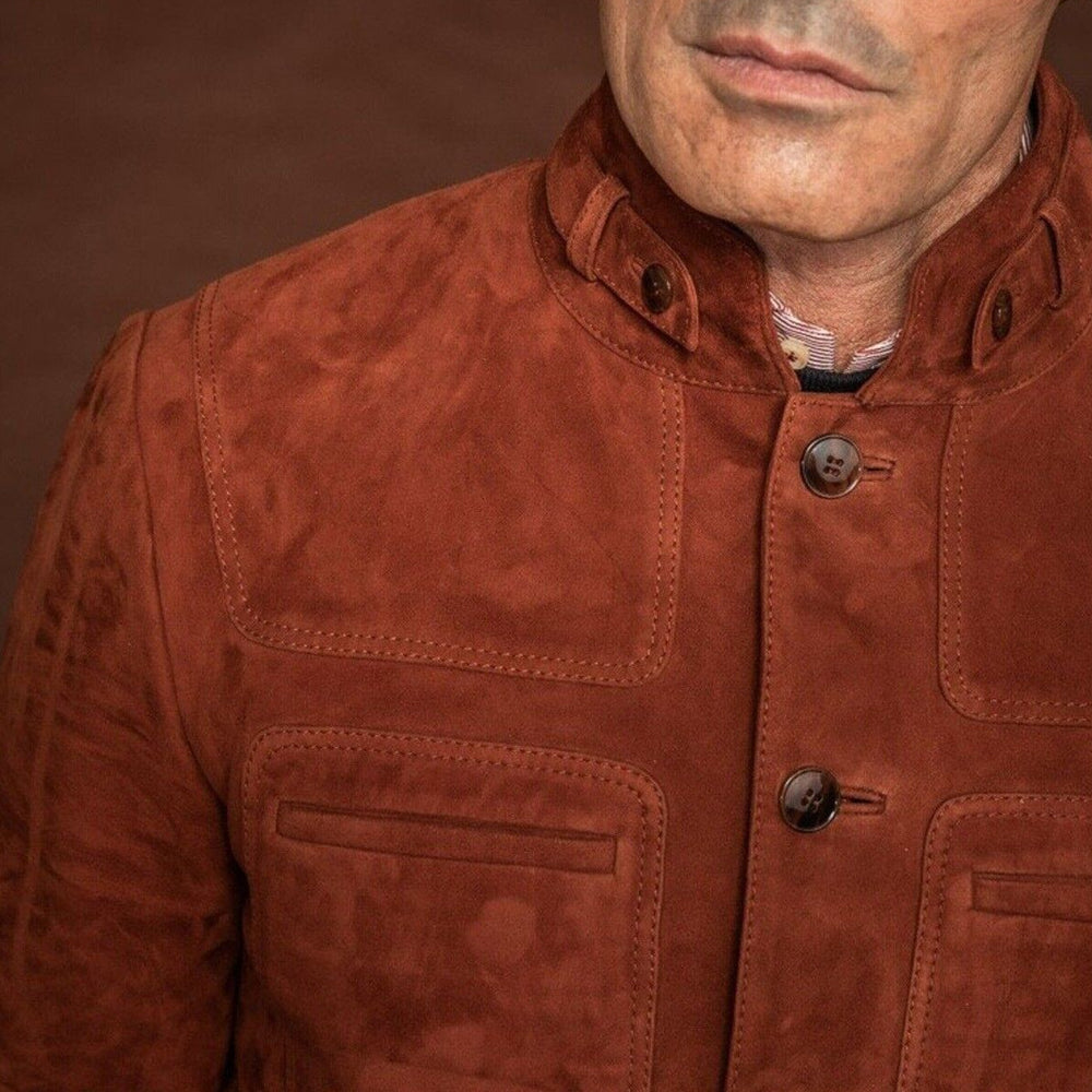 Close-up of the men's brown suede lambskin leather jacket, focusing on the chest pocket, collar, and fine craftsmanship.