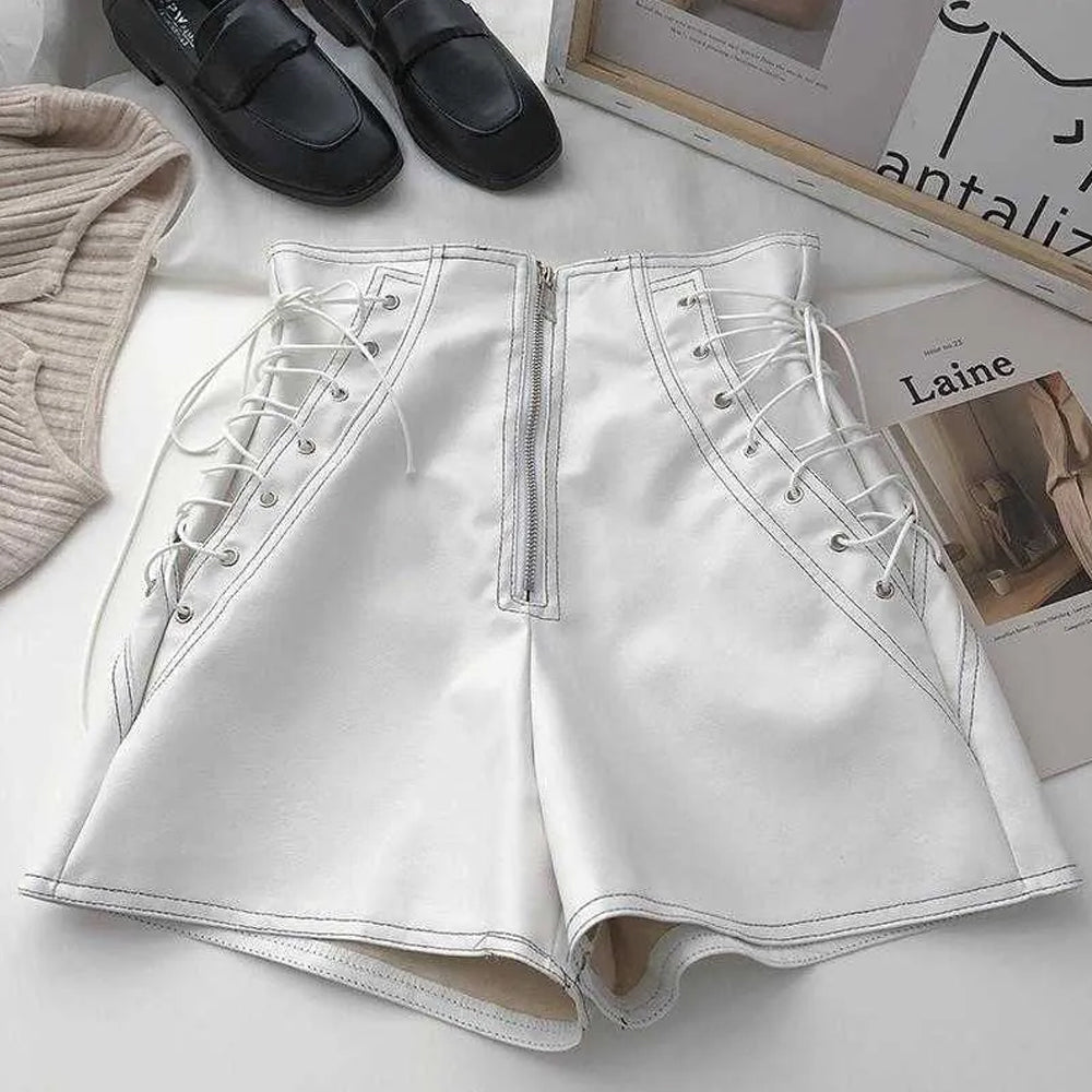 White leather shorts styled for a chic streetwear outfit.