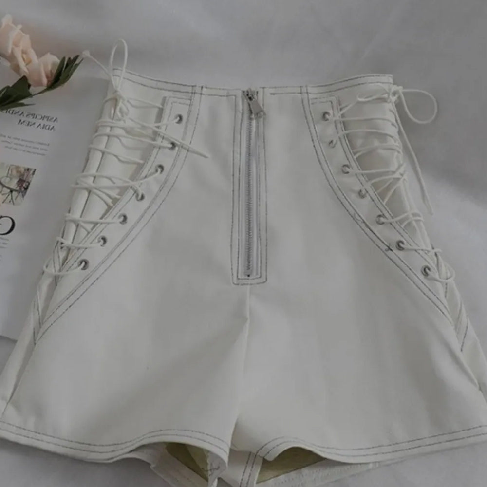 Adjustable lace-up sides on women’s white leather shorts.