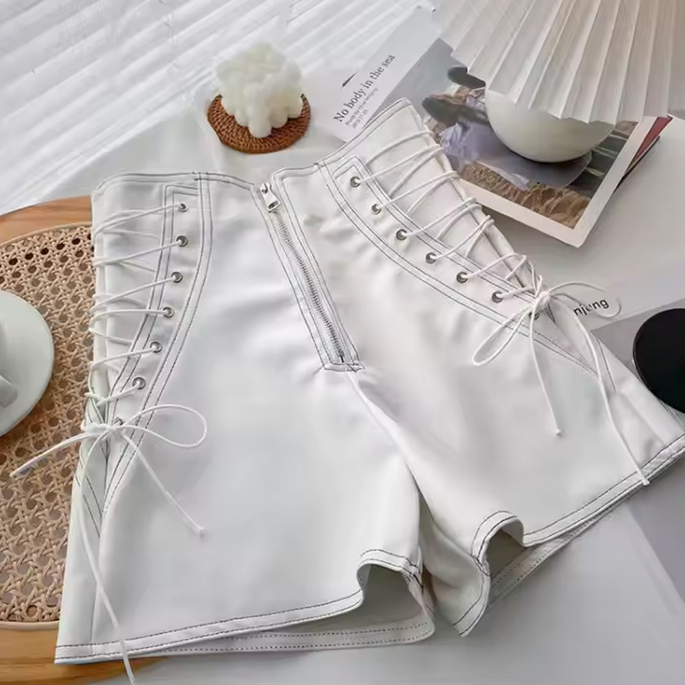 Close-up of high-waisted white leather shorts with corset lacing.