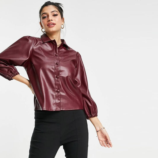 Woman confidently wearing a wine-red sheepskin leather balloon sleeve shirt, standing stylishly.