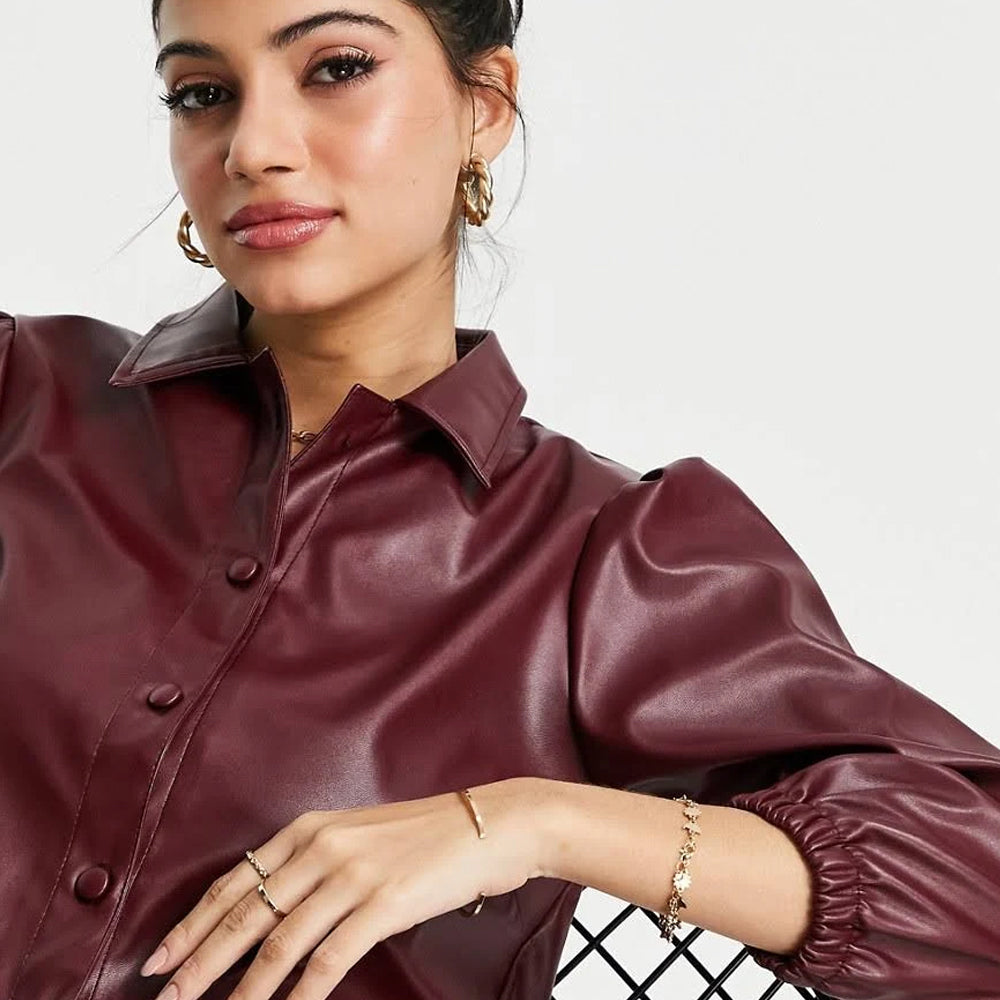 Close-up of woman in wine-red sheepskin leather balloon sleeve shirt with button closure and turn-down collar.