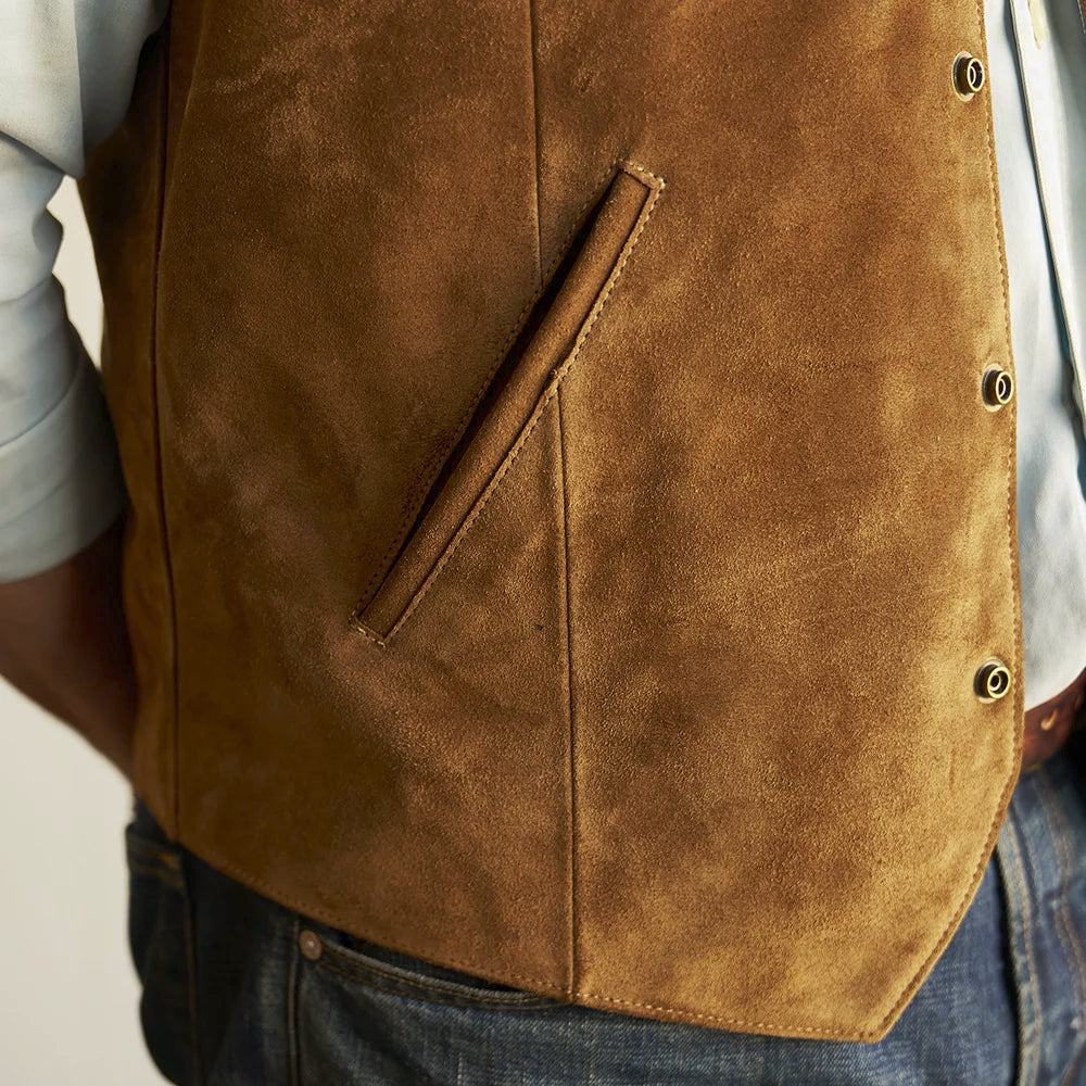 Close-up of the slanted double-welt hand pocket and reinforced vertical panel seam on the tan suede vest