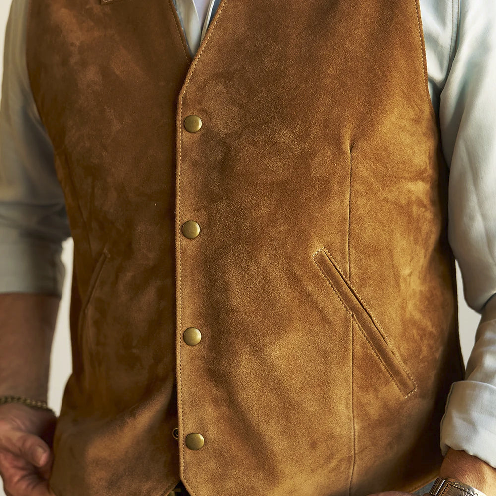 Close-up of antique-brass snaps, fine caramel suede nap and an angled double-welt pocket on the men’s vest