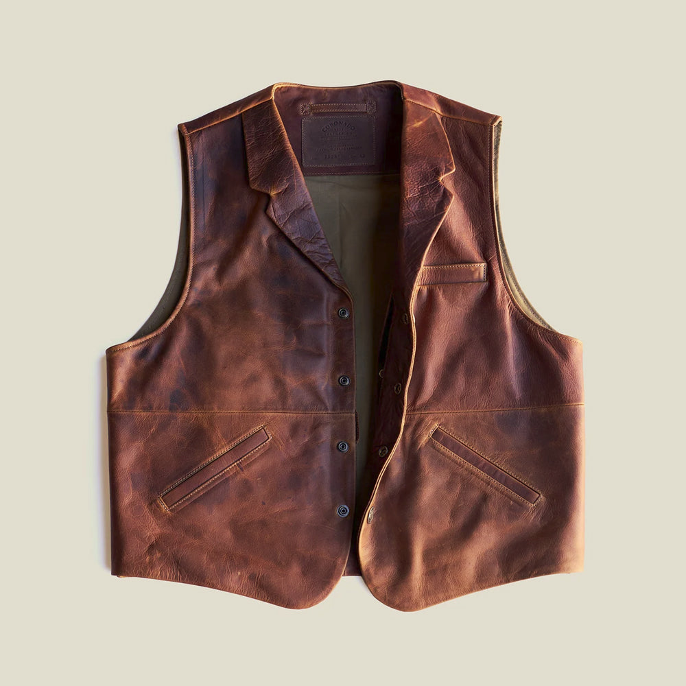 Open front of antique pull-up leather vest displaying the notched collar, snap placket, cotton lining and welt pocket arrangement